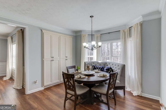 dining area featuring ornamental molding, plenty of natural light, and dark wood finished floors