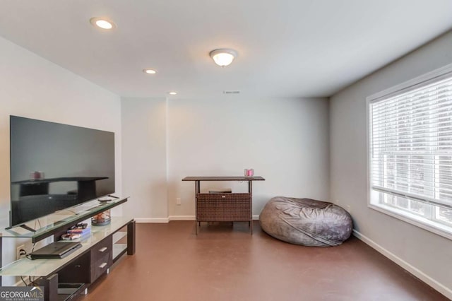 interior space featuring finished concrete flooring, recessed lighting, visible vents, and baseboards