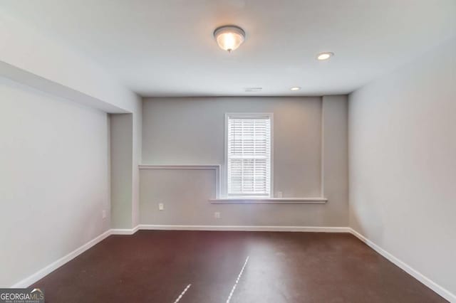 unfurnished room featuring recessed lighting and baseboards