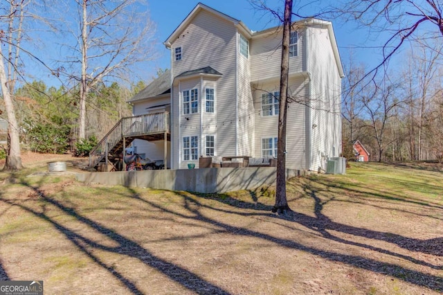 view of property exterior with stairs, a yard, central AC unit, and a wooden deck