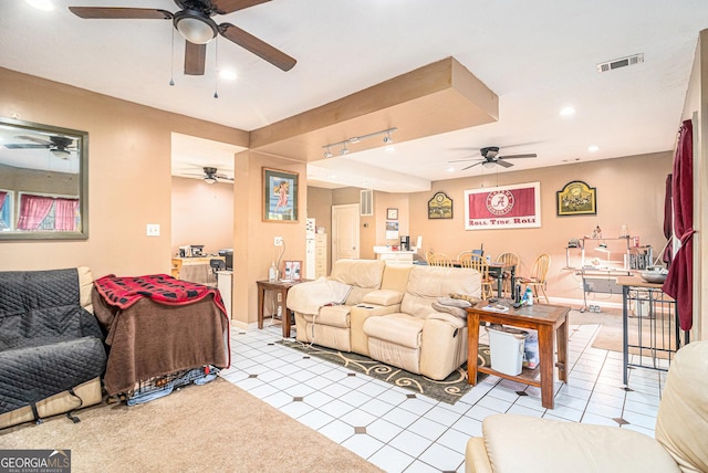 living area featuring light tile patterned flooring, recessed lighting, visible vents, baseboards, and rail lighting