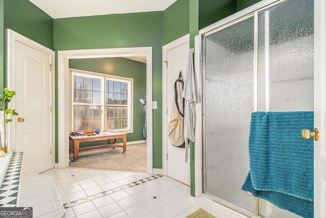 bathroom with a shower stall and tile patterned floors