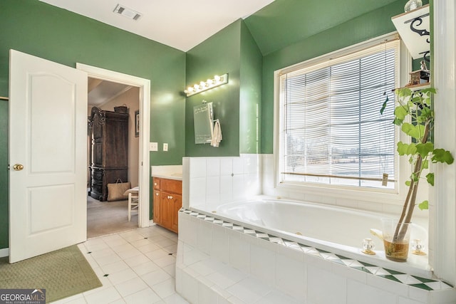 full bathroom with tile patterned floors, visible vents, vanity, and a bath