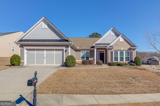 craftsman-style home featuring driveway, a standing seam roof, a garage, and brick siding