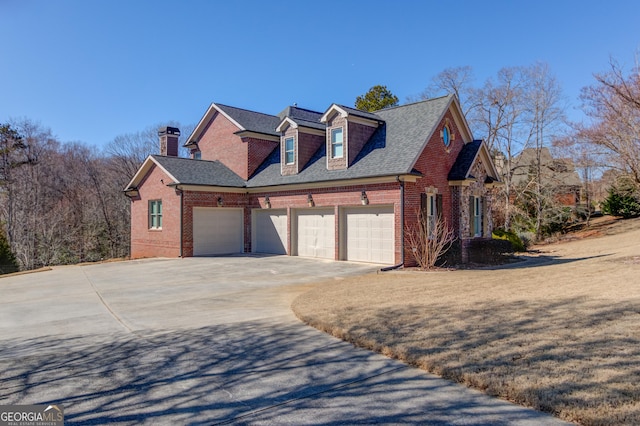 5016 Deer Creek Ct, Flowery Branch, GA 30542 - view of property exterior with brick siding, an attached garage, concrete driveway, and a chimney