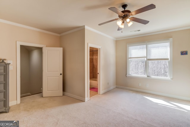 unfurnished bedroom with baseboards, ornamental molding, visible vents, and light colored carpet