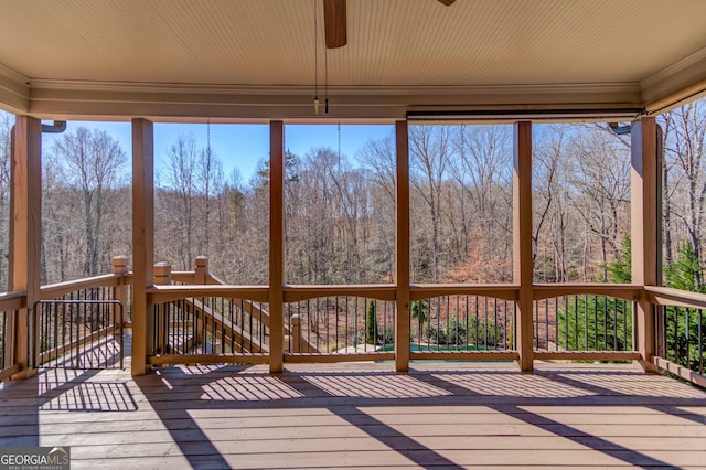 wooden terrace with a wooded view