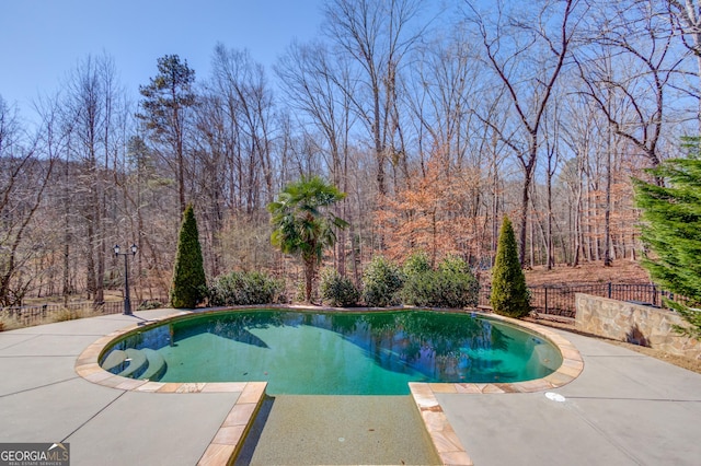 5016 Deer Creek Ct, Flowery Branch, GA 30542 - view of pool with a fenced in pool, fence, a patio, and a wooded view