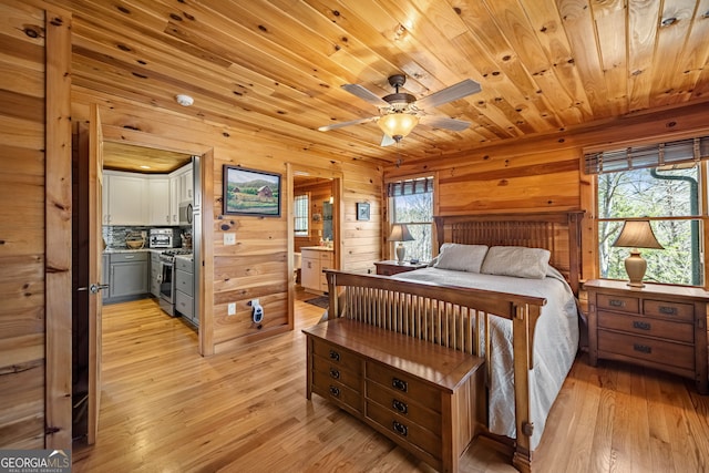 bedroom with multiple windows, light wood-type flooring, and wooden ceiling