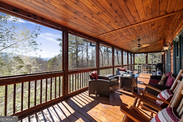 sunroom featuring wooden ceiling, vaulted ceiling, and ceiling fan