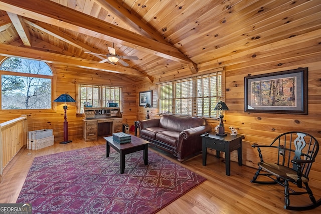 living room with lofted ceiling with beams, wood ceiling, and a wealth of natural light