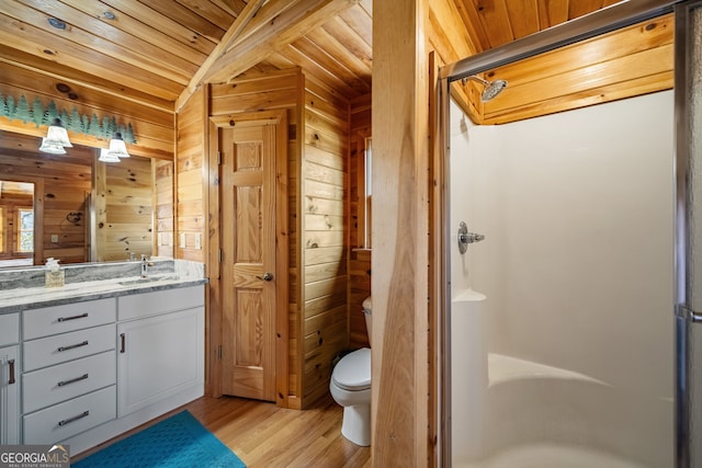 full bath with wooden ceiling, wooden walls, wood finished floors, vanity, and a shower stall