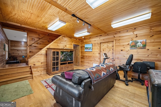 living room with wooden ceiling, light wood-style flooring, wood walls, and rail lighting