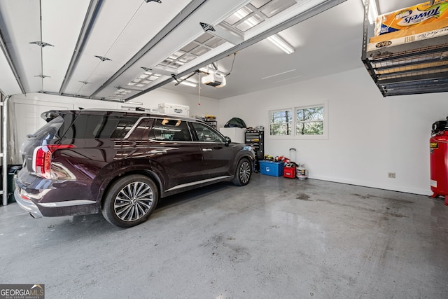 garage with baseboards and a garage door opener