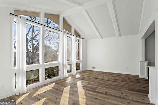 interior space with visible vents and vaulted ceiling with beams