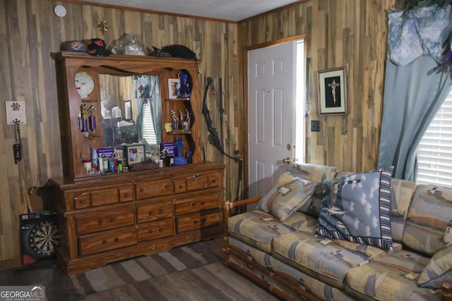 living room featuring crown molding and wooden walls