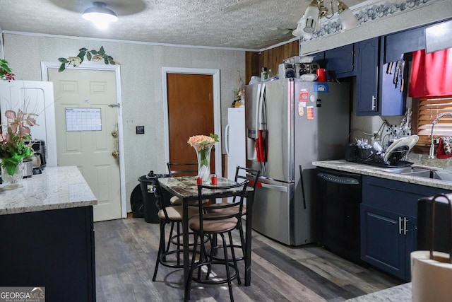 kitchen featuring black dishwasher, crown molding, a sink, and blue cabinets