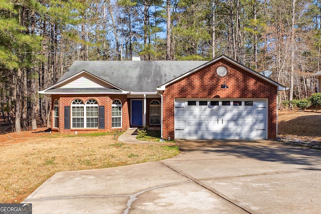 single story home featuring brick siding, a front lawn, concrete driveway, a chimney, and an attached garage