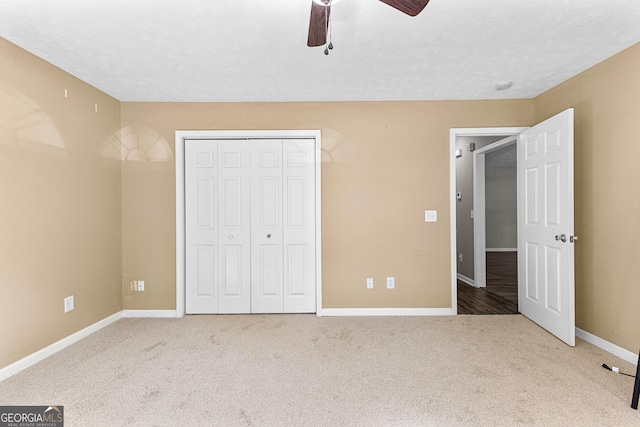 unfurnished bedroom with a ceiling fan, carpet flooring, baseboards, and a closet