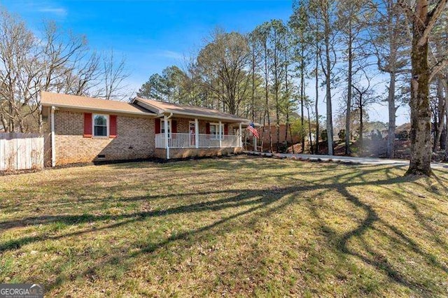 view of front of property featuring a porch, crawl space, a front yard, and brick siding