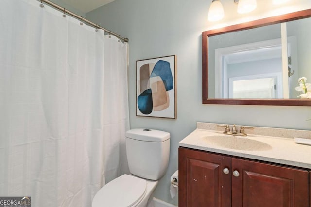 bathroom with toilet and vanity