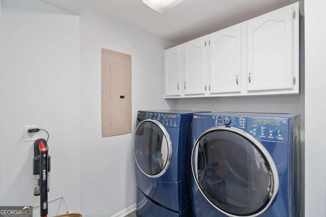 laundry room with baseboards, cabinet space, electric panel, and washer and dryer