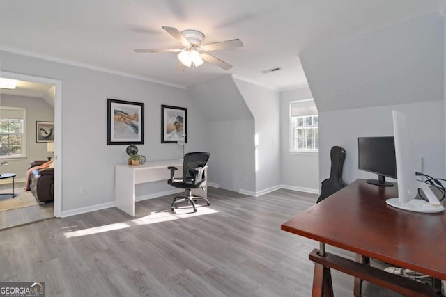 office with ornamental molding, a wealth of natural light, and light wood-style flooring