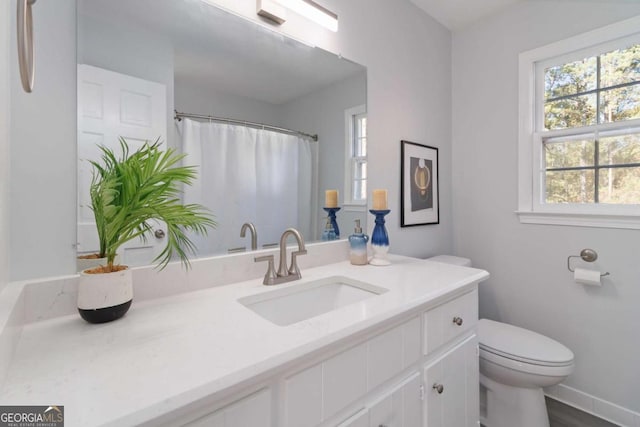 full bath featuring toilet, baseboards, and vanity