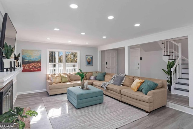 living room with light wood-style floors, stairs, and recessed lighting