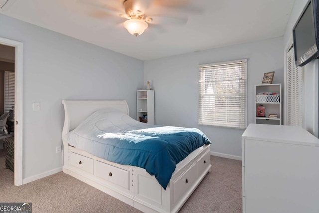 bedroom featuring light carpet and baseboards