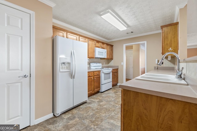 kitchen featuring white appliances, ornamental molding, brown cabinets, light countertops, and a sink