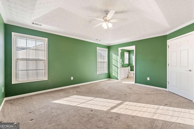 unfurnished bedroom with light carpet, a textured ceiling, and baseboards