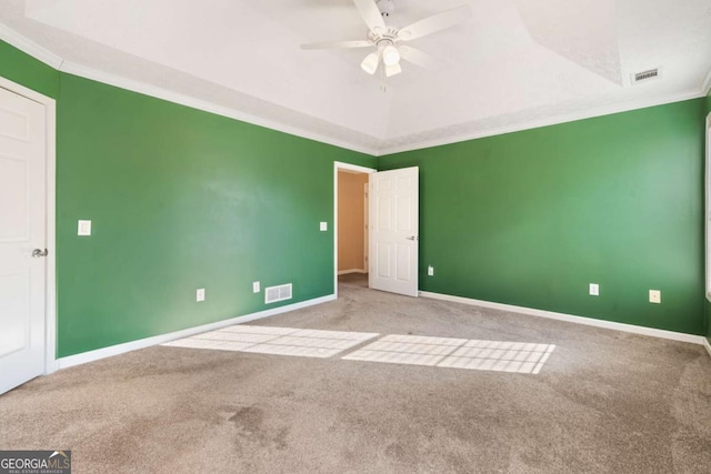 unfurnished room featuring baseboards, visible vents, a ceiling fan, light colored carpet, and crown molding