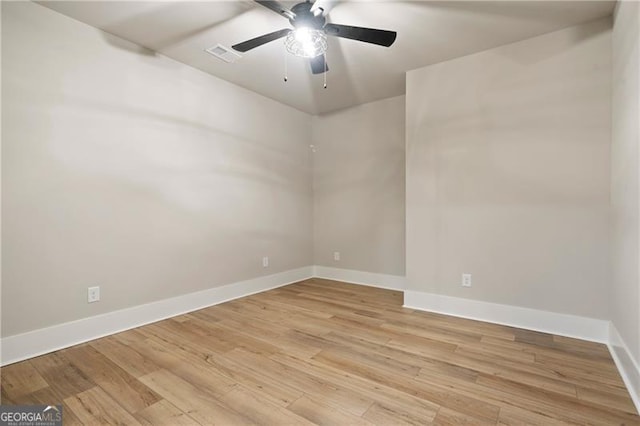 empty room with visible vents, ceiling fan, light wood-style flooring, and baseboards