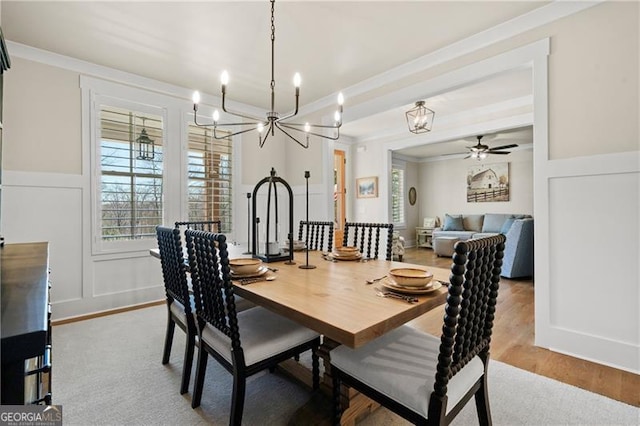 6326 Point Twenty Two, Gainesville, GA 30506 - dining space featuring ornamental molding, wainscoting, ceiling fan with notable chandelier, wood finished floors, and a decorative wall