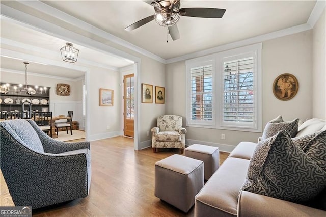 6326 Point Twenty Two, Gainesville, GA 30506 - living area with ceiling fan with notable chandelier, crown molding, baseboards, and wood finished floors