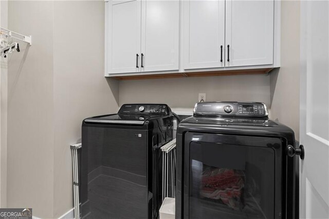 washroom featuring cabinet space and independent washer and dryer