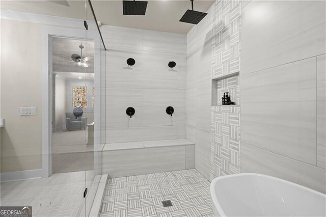 full bathroom with ceiling fan, a freestanding tub, a shower stall, and visible vents