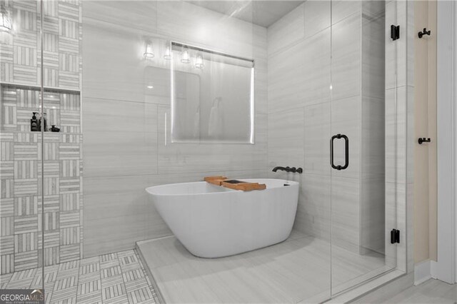 6326 Point Twenty Two, Gainesville, GA 30506 - bathroom with a shower stall, a freestanding tub, and tile walls