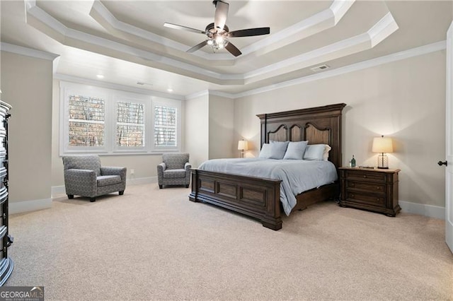 bedroom with a tray ceiling, carpet, crown molding, and baseboards