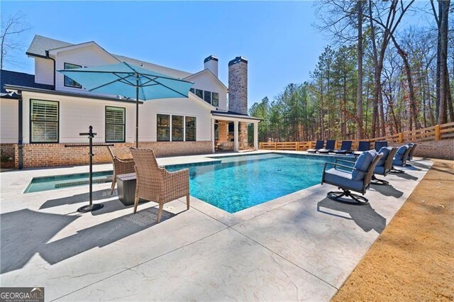 view of pool featuring a patio, fence, and a fenced in pool