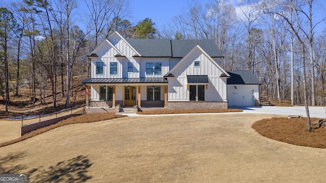 rear view of property with driveway, a garage, a shingled roof, a chimney, and central air condition unit