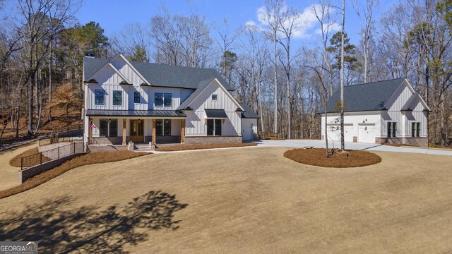 entrance to property with french doors, a porch, board and batten siding, and brick siding