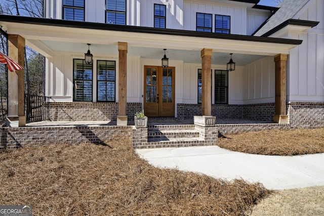 modern farmhouse style home with a standing seam roof, curved driveway, metal roof, and board and batten siding