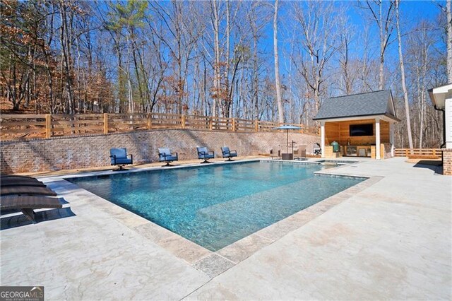 view of swimming pool featuring a fenced in pool, a fenced backyard, and a patio