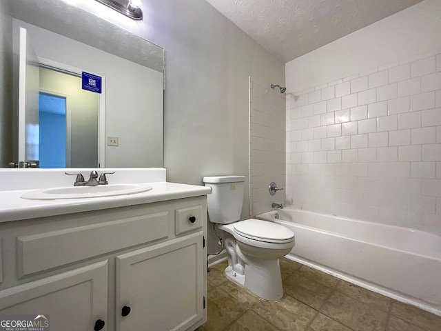 full bathroom featuring a textured ceiling, shower / washtub combination, vanity, and toilet