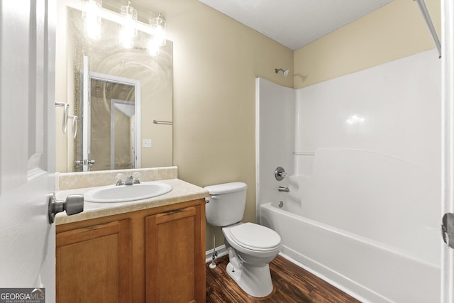 full bath featuring toilet, shower / tub combination, wood finished floors, a textured ceiling, and vanity