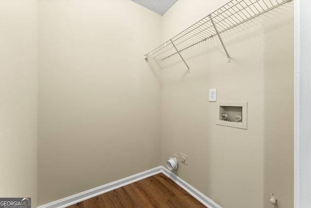 clothes washing area with laundry area, baseboards, dark wood finished floors, hookup for a washing machine, and electric dryer hookup