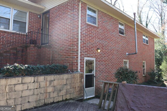 view of side of home with brick siding