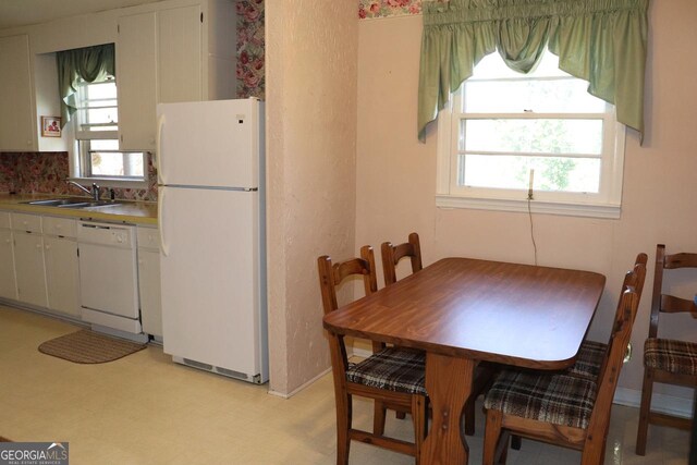 dining room featuring light floors and plenty of natural light